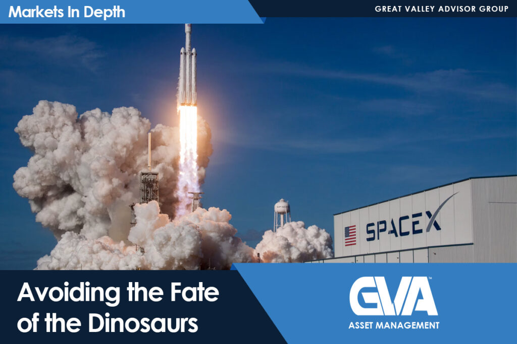 Rocket launch at SpaceX with massive exhaust plumes against a blue sky, storefront branding visible on the right.